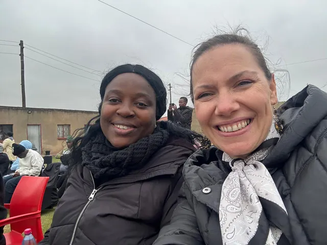 Two women smiling together at a WOWZA gathering in Thembisa
